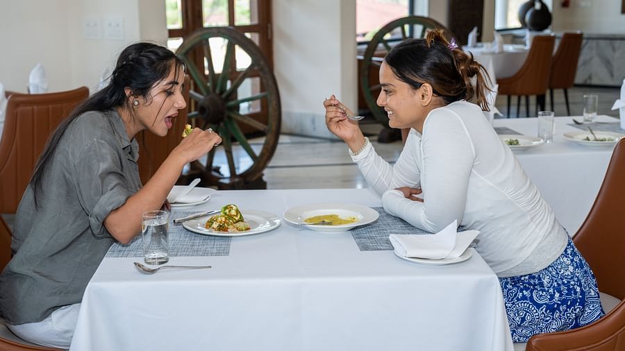 Two women have a meal at in-house restaurant in Udaipur - Rajbagh Wellness, Udaipur
