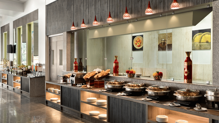 A diverse buffet spread is presented for diners at the Jalpaan restaurant venue at Ramada by Wyndham Bodh Gaya Mahabodhi.