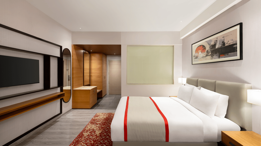 The Standard King Room at Ramada by Wyndham Bodh Gaya Mahabodhi featuring the clean bedding and sleek bedroom furniture.