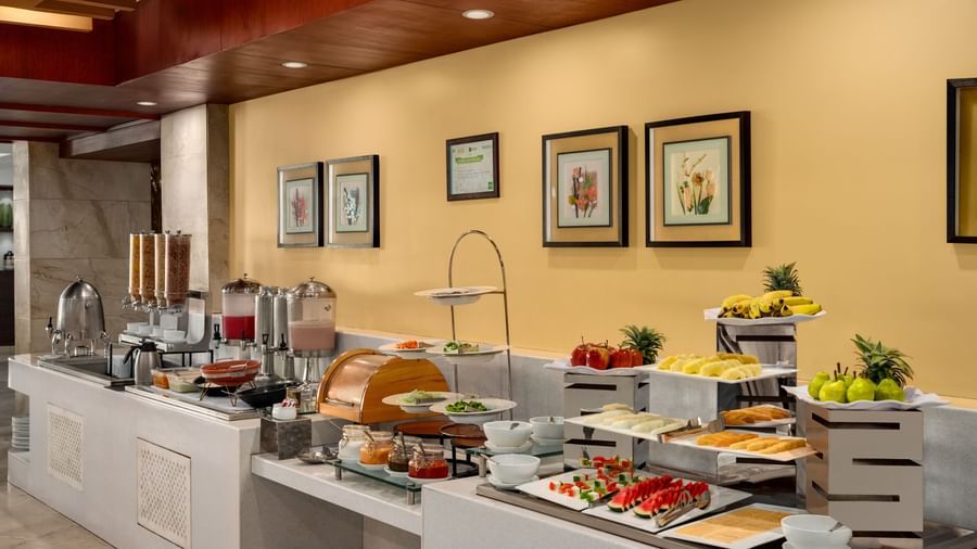 Breakfast buffet area with fresh food display and dining setup at Ramada by Wyndham Ghaziabad Vasundhara