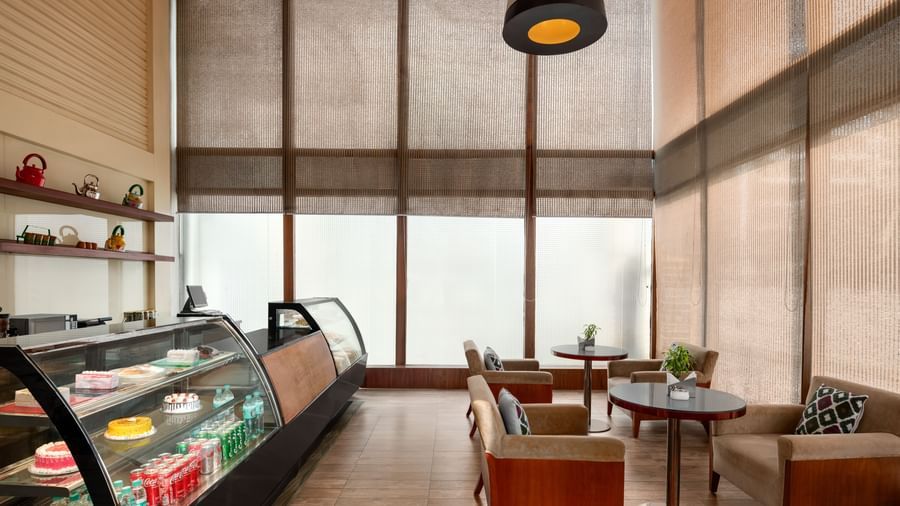 Upscale restaurant with glass partitions and refined ambiance at Ramada by Wyndham Ghaziabad Vasundhara