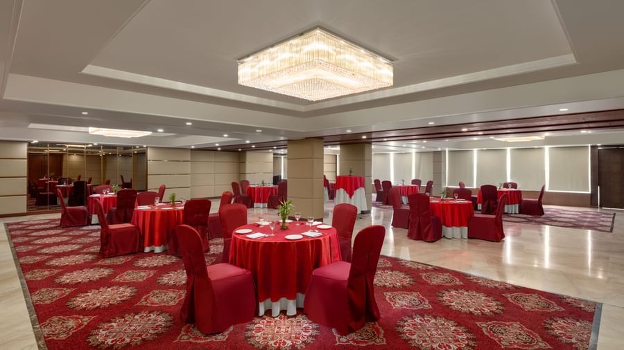 Emerald Meeting Room with red chairs and professional conference setup at Ramada by Wyndham Ghaziabad Vasundhara