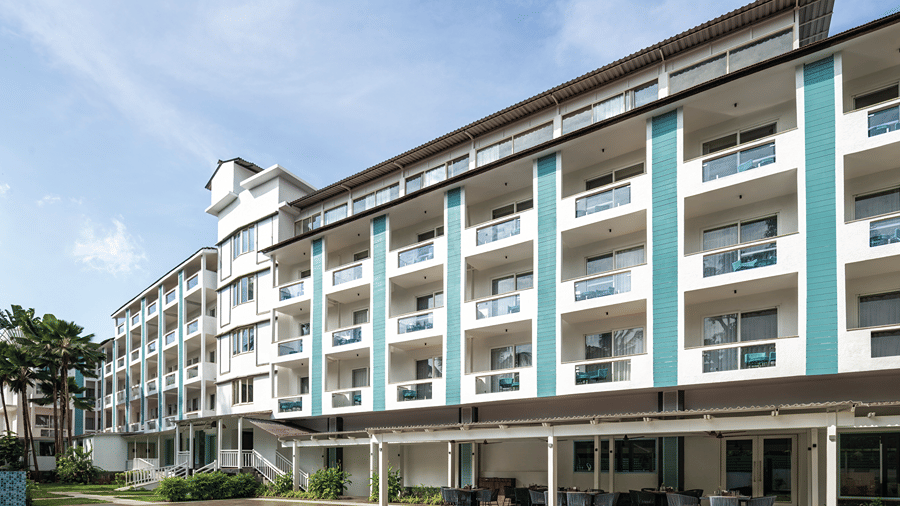 Exterior view of the hotel building overlooking the swimming pool.