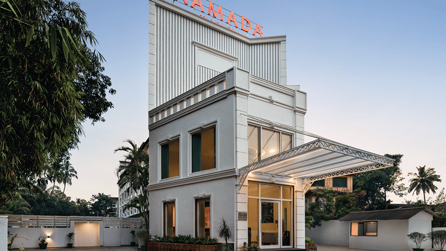 Hotel entrance with a covered driveway and landscaped surroundings.