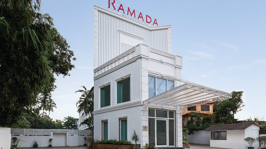 Hotel entrance with a covered driveway and landscaped surroundings.