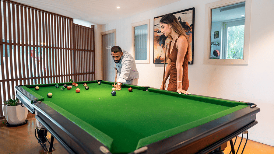 Indoor billiards table set up in a recreation room.