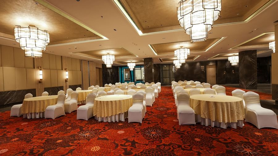 Lavish banquet space featuring a red patterned carpet and stylish lighting at Ramada by Wyndham Sonipat Murthal