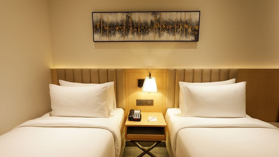 Comfortable  bedroom with elegant decor and bedside lamps at Ramada by Wyndham Sonipat Murthal
