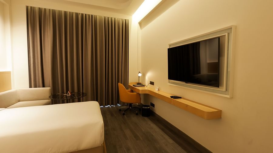 Cosy room with comfortable bed, flat-screen TV, and ambient lighting at Ramada by Wyndham Sonipat Murthal