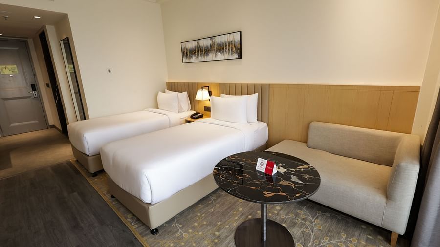 Well-furnished bedroom with sofa and coffee table at Ramada by Wyndham Sonipat Murthal