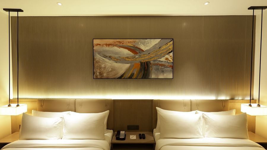 Room with elegant lighting and wall art above the headboard at Ramada by Wyndham Sonipat Murthal