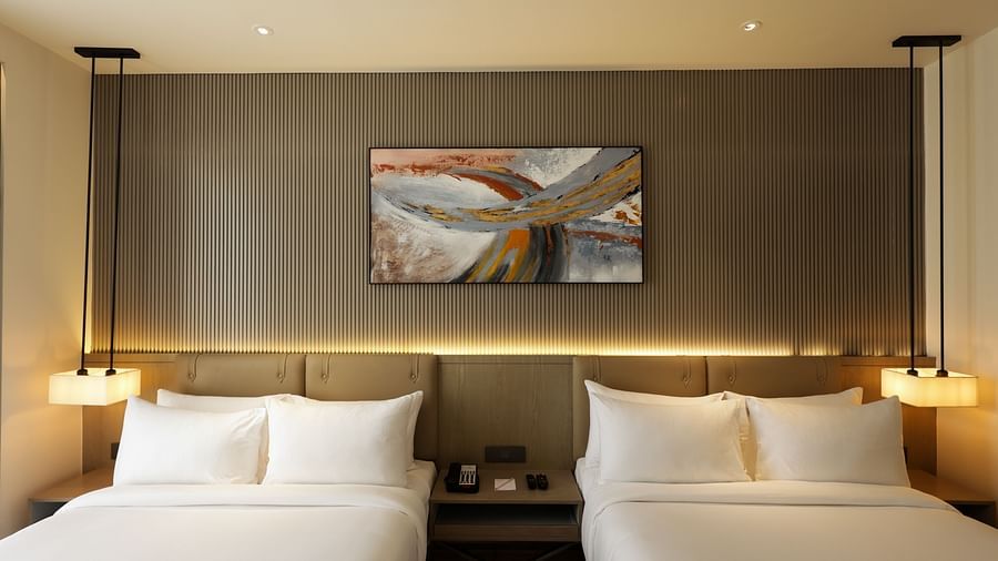 Room with soft lighting, grey accent wall, and abstract wall art at Ramada by Wyndham Sonipat Murthal