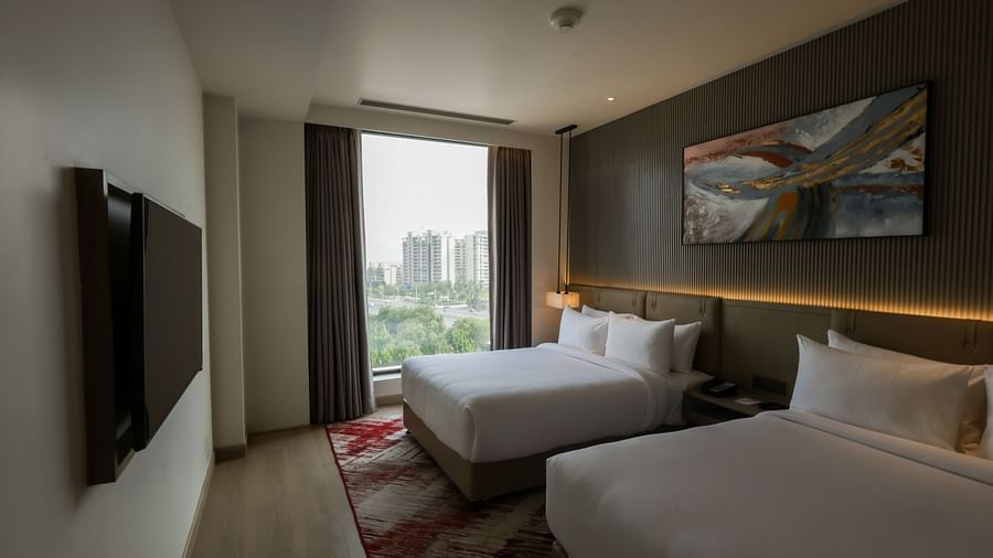 Bedroom with floor-to-ceiling window and outside view at Ramada by Wyndham Sonipat Murthal