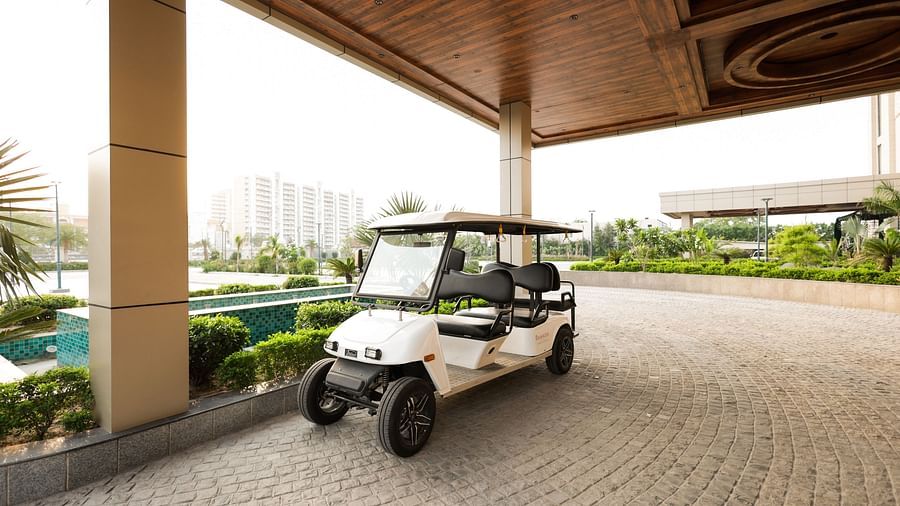 Golf cart parked under shaded driveway at Ramada by Wyndham Sonipat Murthal