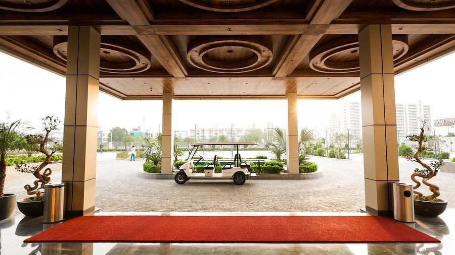 Covered drop-off area with intricate wooden ceiling at Ramada by Wyndham Sonipat Murthal