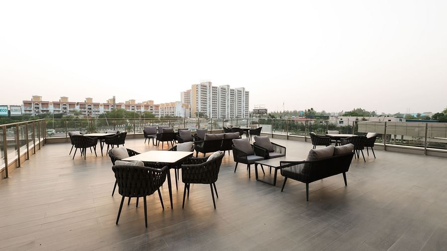 Rooftop seating with city views and modern dining setup at Ramada by Wyndham Sonipat Murthal