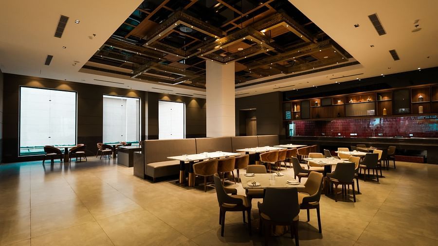 Warmly lit restaurant with elegant ceiling design at Ramada by Wyndham Sonipat Murthal