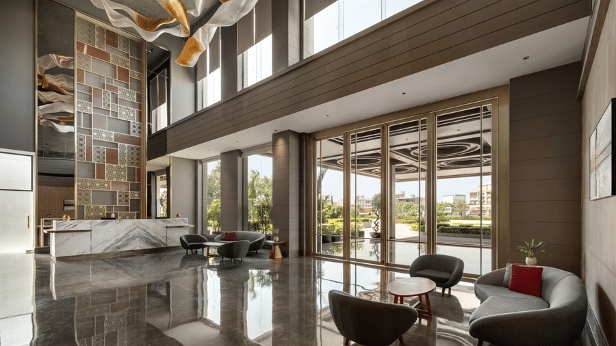 Spacious hotel lobby with high ceilings, elegant interiors, and contemporary seating arrangements at Ramada by Wyndham Sonipat Murthal.