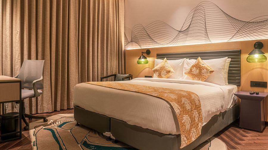 A king size bed of a room at Ramada Encore, Bhiwadi.
