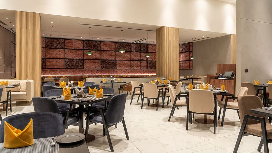 Dining setting with cutlery on a table at Ramada Encore, Bhiwadi.