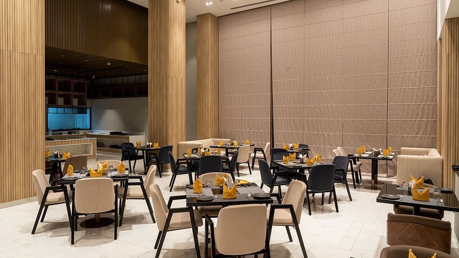 Dining setting with cutlery on a table at Ramada Encore, Bhiwadi.