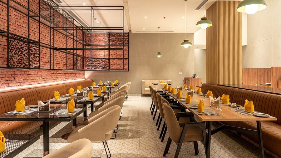 Dining setting with cutlery on a table at Ramada Encore, Bhiwadi.