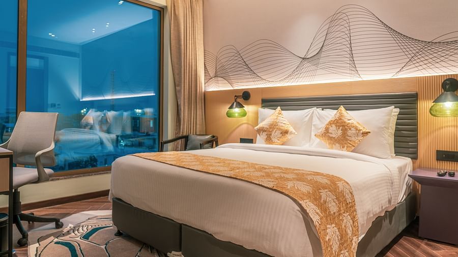 A king size bed of Suite at Ramada Encore, Bhiwadi.
