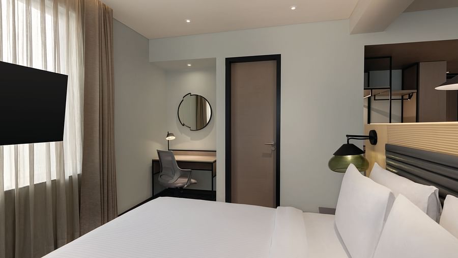 Ramada Encore by Wyndham, Bhiwadi | Hotel room with white bed, TV, and a view into the bathroom door
