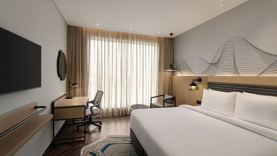 Ramada Encore by Wyndham, Bhiwadi | Hotel bedroom with a work desk, chair, and a view of the bed.