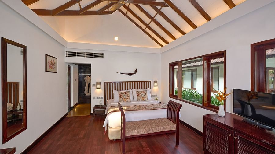 a double bed inside one of the rooms - Rhythm Kumarakom