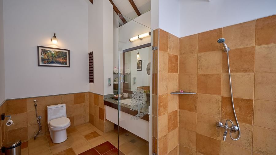 an overview of a bathroom inside one of the rooms - Rhythm Kumarakom