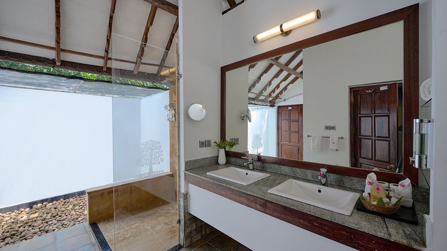 an overview of a bathroom inside one of the rooms - Rhythm Kumarakom
