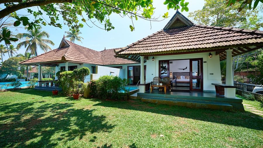 an image of a cottage with a classic tiled roof provides a calm and scenic environment for a peaceful getaway - Rhythm Kumarakom
