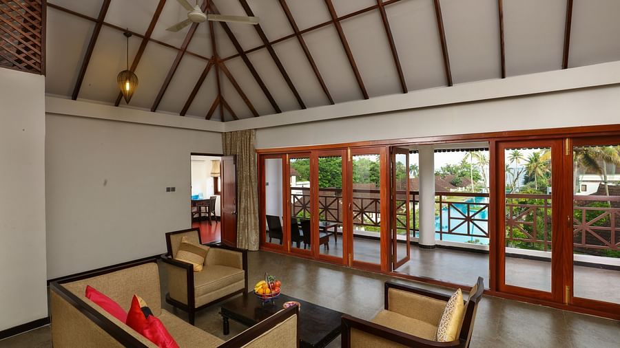 an image of a living area featuring sofas and a table - Rhythm Kumarakom
