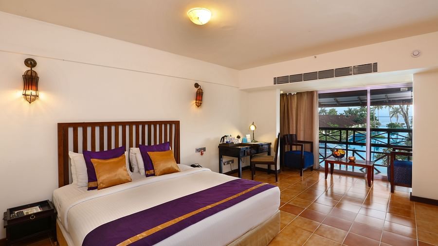 an image of a Lake View Terrace Room with a double bed  with lights on each sides  - Rhythm Kumarakom