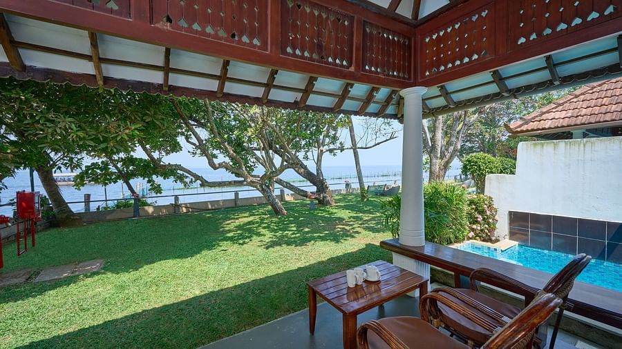a view from inside a balcony of the garden - Rhythm Kumarakom