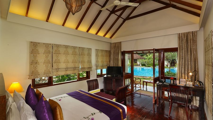 An image of a room featuring a bed, a tv and a study desk - Rhythm Kumarakom