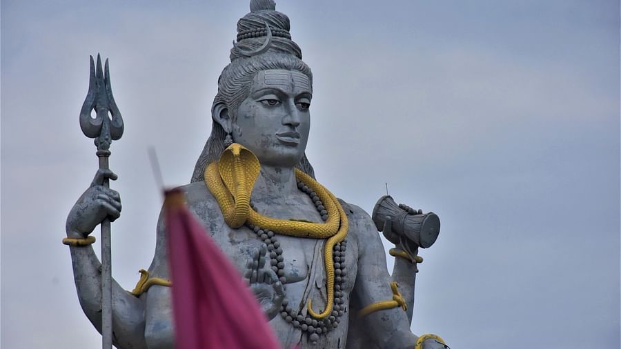 Close-up of a stone statue of Lord Shiva draped in red fabric- Kumarakom 