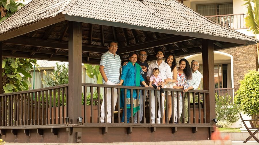 Family posing for a picture under an open hut - Rhythm Lonavala