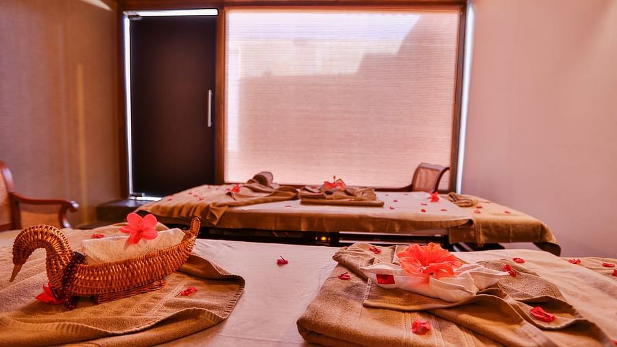 an image of a folded sheets on a spa table with decorations inside soham spa - Rhythm Lonavala