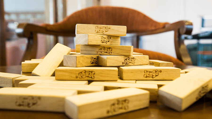a close up shot of Jenga blocks kept on a table - Rhythm Lonavala