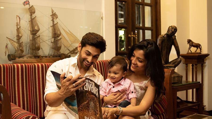 Parents amusing their kid with the Traveller magazine - Rhythm Lonavala