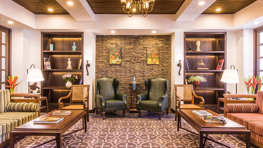 Well-kept library with chairs and couch - Rhythm Lonavala