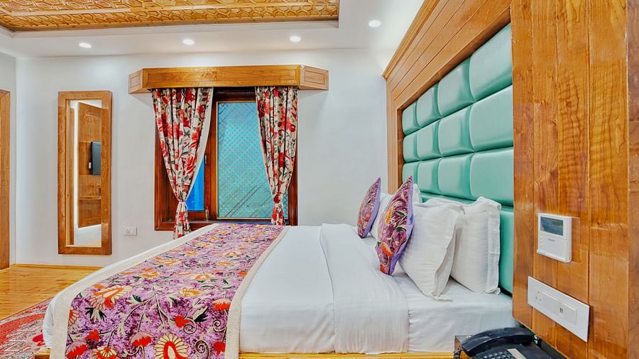 Stylish twin bed setup with bright curtains and a cosy atmosphere at Royal Comfort Regency, ideal for a peaceful escape.