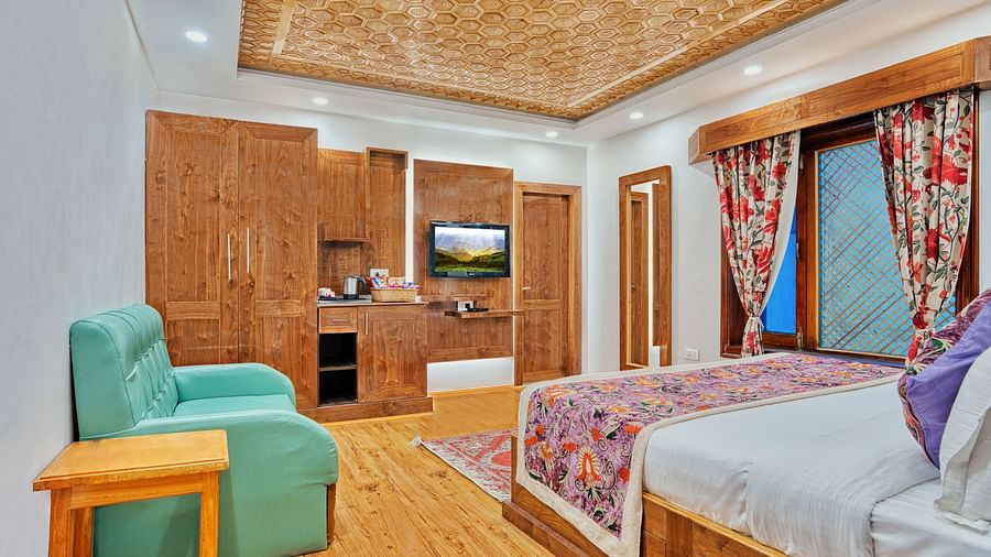Well-appointed guest room with modern amenities and vibrant decor at Royal Comfort Regency, offering comfort in every detail.