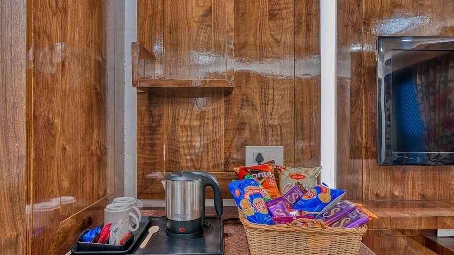 In-room tea and coffee station with a selection of refreshments at Royal Comfort Regency, ensuring added comfort and convenience.