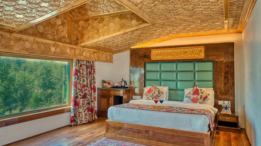Sunlit room with lush outdoor views and refined design at Royal Comfort Regency, ideal for a refreshing retreat.