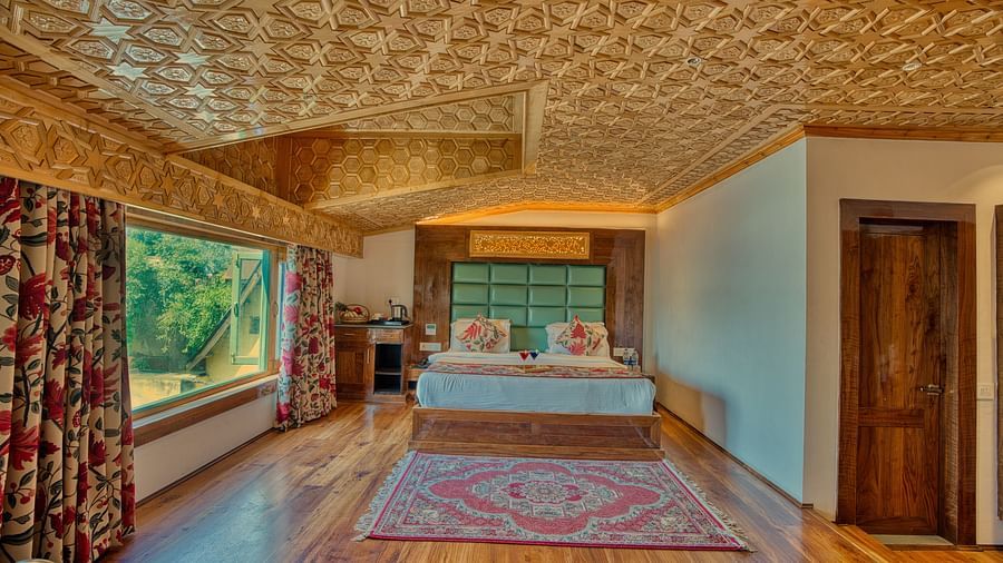 Cosy bedroom with scenic window views and traditional decor at Royal Comfort Regency, perfect for a tranquil stay.