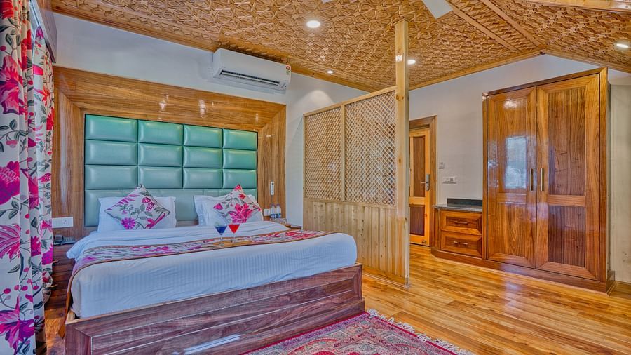 Serene bedroom at Royal Comfort Regency featuring plush bedding and ambient lighting for a luxurious, quiet escape.
