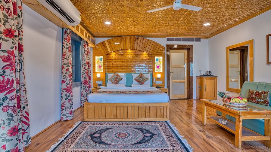 Bright bedroom at Royal Comfort Regency with patterned curtains, a king size bed and vibrant decor for a pleasant stay.